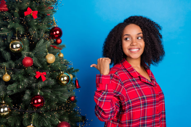 头像照片惊讶的年轻黑发女士点看树穿红色睡衣孤立在蓝色的背景图片下载