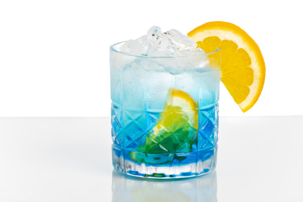 蓝色鸡尾酒，橙色和黄瓜点缀在白色的背景上。图片下载