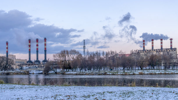 城市海滨附近火电厂冒烟的烟囱。冬天。工业和自然背景。图片下载