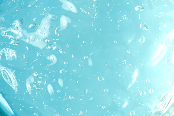 蓝色液体凝胶纹理背景。带有气泡的抽象液体。化妆品的样布图片下载