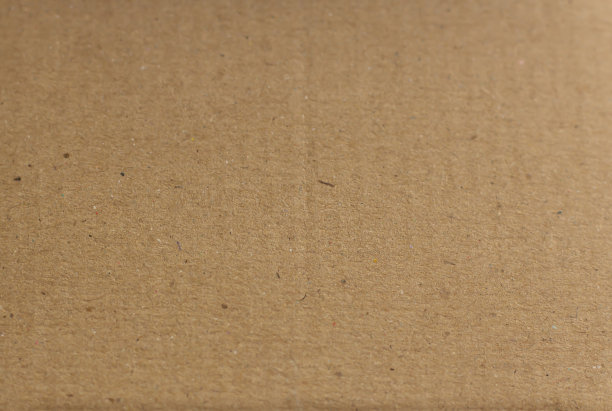 关闭棕色纸盒，有一点粗糙和沟槽，由回收纸制成。背景和纹理。图片下载