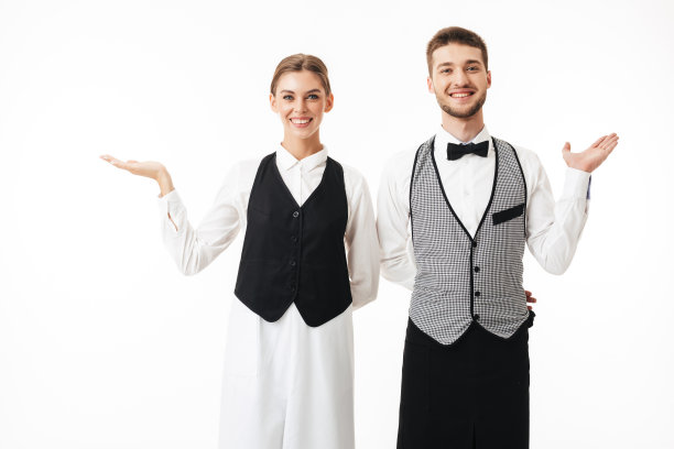 穿着白衬衫和白背心的年轻微笑的服务员和漂亮的服务员愉快地看着镜头，在白色背景下摆着相同的姿势图片下载
