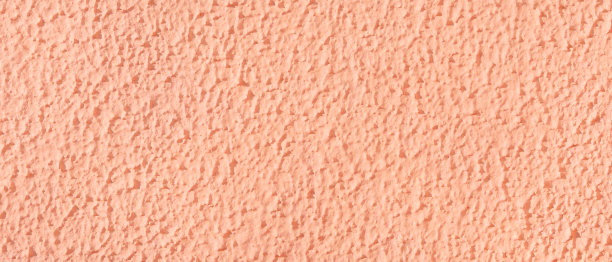 有纹理的表面涂灰泥墙粉红色。图片下载