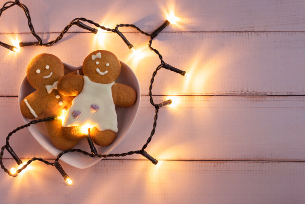 姜饼曲奇放在木制背景上心形的碗里。图片下载