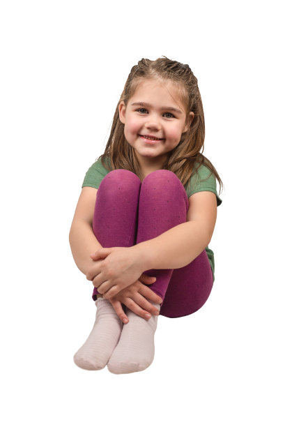 孤立的女孩坐在她的膝盖与她的手和微笑在一个白色的背景图片下载