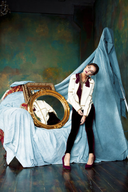 美丽富有的黑发女人在豪华的内饰附近空框，穿着时尚的衣服，生活方式的人的概念图片下载