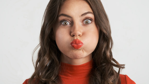 漂亮的黑发女孩的肖像在白色背景的相机上嬉戏图片下载