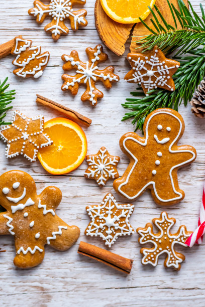 圣诞姜饼和糖果放在木桌上。星星和雪花形状的饼干和甜食。冬季主题，乡村风格。旁边是松树。糖果棒和其他香料。图片下载