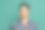 年轻英俊冷静的男子，学生穿着温暖的格子衬衫孤立在绿色的工作室背景。图片下载