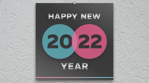 在黑色挂历的头版上，有两种颜色的文字:新年快乐和数字2022图片下载