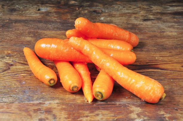 新鲜胡萝卜放在木头上图片下载