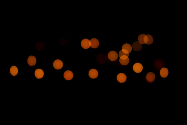 橙色散景球和完整的黑色背景图片下载