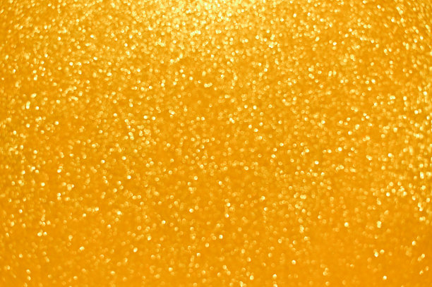 金色的抽象背景。闪闪发光的圣诞灯。模糊抽象的背景图片下载