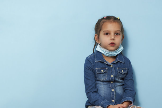 蓝色背景上戴着面具的小女孩图片下载