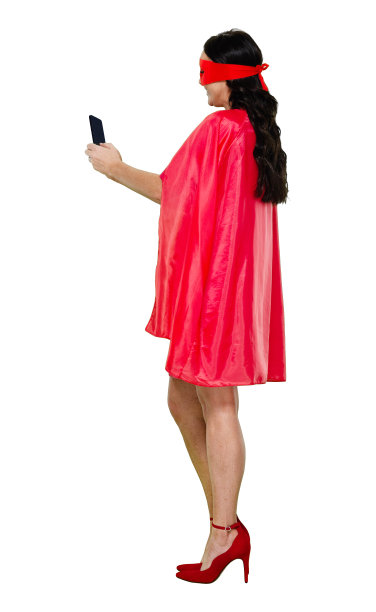 白人女性穿着斗篷站在白色背景前，用手机拍照图片下载