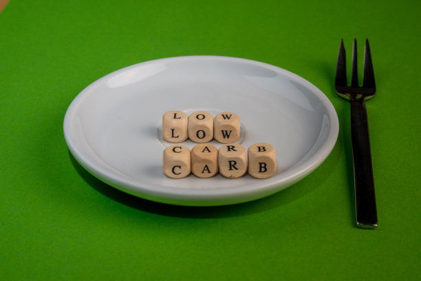空的白色盘子与字母立方体和字低碳水化合物，蛋糕叉子，概念图片图片下载