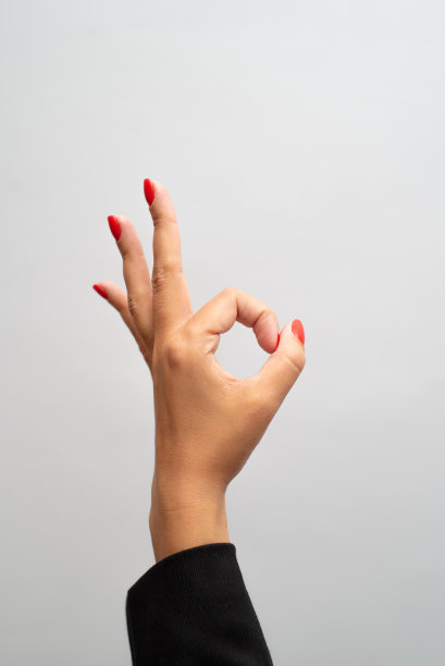红色指甲的女性手在白色背景上显示手势图片下载