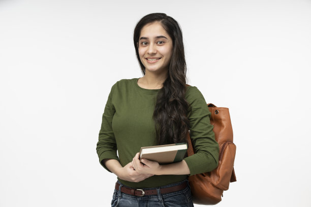 女十几岁的学生背着书包和书微笑的股票照片图片下载