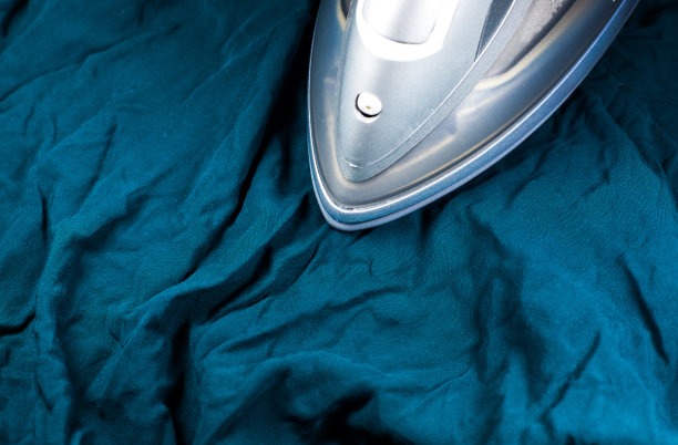 用熨斗熨衬衫的人会把衣服烫得皱巴巴的。图片下载