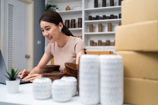 亚洲美女在家在线直播卖花瓶产品。年轻漂亮的女孩用笔记本电脑向顾客展示商品并呈现细节。远程购买和购买购物概念图片下载