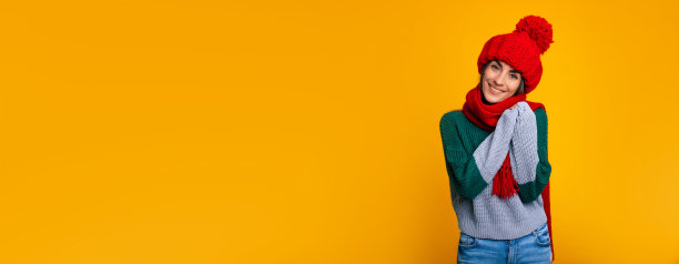 大宽横幅照片快乐年轻美丽的女人在红色的帽子和围巾摆孤立在黄色的背景图片下载