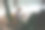 戴眼镜的白人女性，拿着杯子坐在靠窗的扶手椅上，用笔记本电脑工作。远处的景色,好像画框一样。侧视图。集中在工作上。一个卷毛女人在幕后工作图片下载