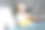 一个小男孩坐在床上的蓝色毯子上玩一部现代手机。图片下载