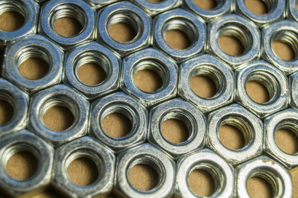 螺栓金属螺母。紧固件。软焦点，行业背景图片下载