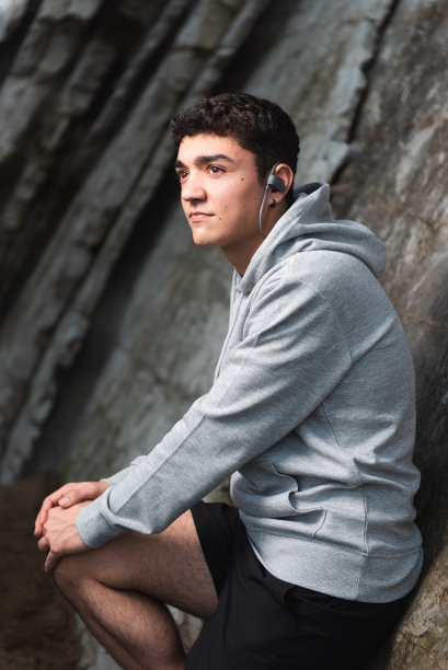 西班牙青年靠墙站着图片下载