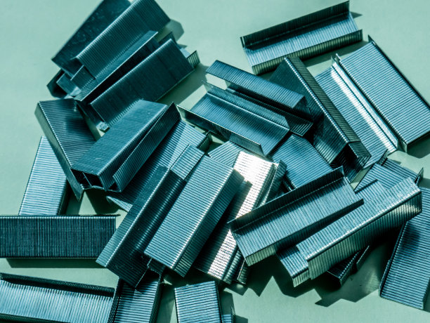 桌子上随意堆放的订书钉图片下载