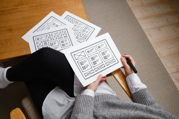 女设计师创建网站设计线框。草图，原型，框架，布局未来设计项目。UI和UX -用户界面，用户体验设计师。网页设计工作室的创意概念图片下载