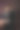 女人坐在椅子上看着相机，背景是黑色和纹理。图片下载