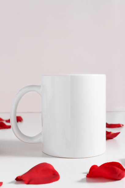 红色花瓣木桌上的白色咖啡杯模型。标志插入模板与复制空间。情人节的浪漫作文。图片下载