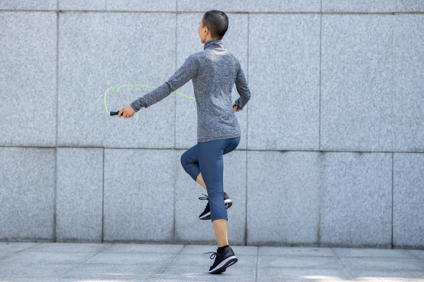 健身女子在城墙上跳绳图片下载