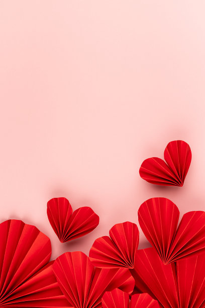 浪漫的情人节背景与激情红纸心作为淡粉色背景的页脚边界，垂直，顶视图，复制空间。喜欢广告背景，文字，卡片。图片下载