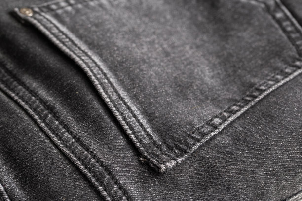 黑色牛仔裤口袋背景，宏观。时尚图片下载