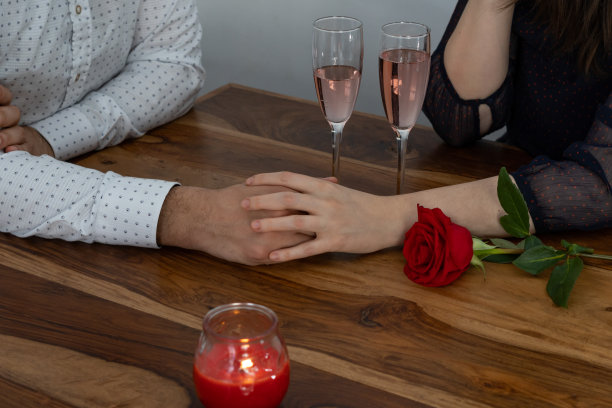 拿着香槟蜡烛和玫瑰的情侣手图片下载