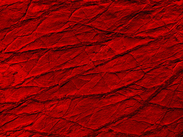 红色色调的石头纹理与裂缝和纹理。特写镜头。它看起来像粗糙的皱巴巴的纸。图片下载
