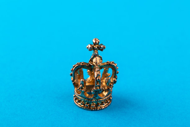 蓝色背景上的小金色皇冠。图片下载
