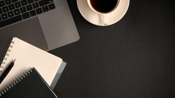 简单的办公空间与笔记本电脑，笔记本，咖啡杯和拷贝空间。图片下载