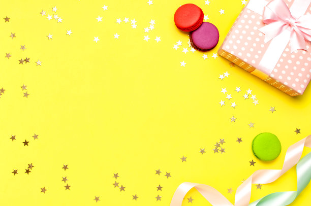 礼品或礼品盒，美丽的节日彩带，蛋糕马卡龙或马卡龙，黄色背景上的五彩纸屑俯视图。平躺作文庆祝，生日，情人节，3月8日，母亲节图片下载
