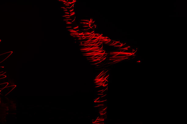 芭蕾舞演员在红灯前跳舞，用华丽的舞蹈动作表达地狱。图片下载