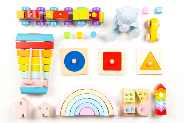 婴儿玩具背景。在白色的背景上，为孩子们安排了五颜六色的教育用木制和毛绒玩具。俯视图，平躺图片下载