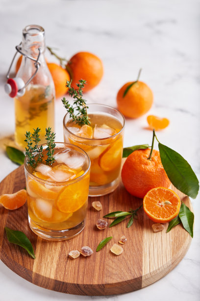加橙汁、冰块和百里香的冰茶。刷新夏季饮料。图片下载
