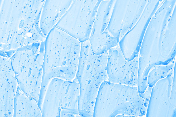 化妆品凝胶或美容啫喱的血清纹理背景。透明皮肤护理胶原蛋白产品背景。抗菌杀菌剂或液态水保湿爽肤水涂抹近距离照片图片下载