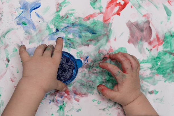 孩子的手用颜料在纸上画特写图片下载