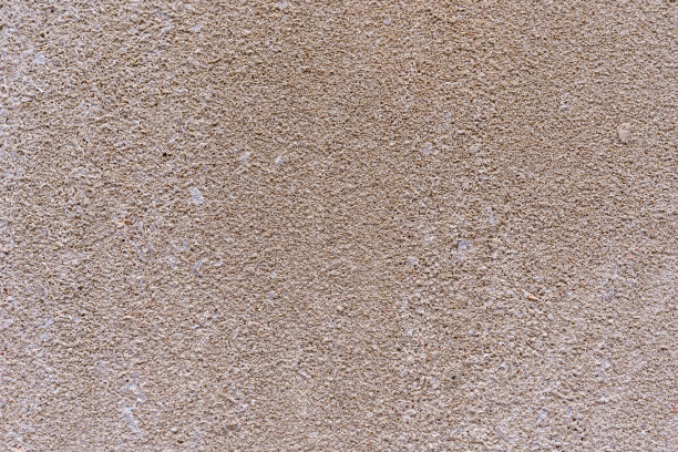 一个粗糙的混凝土立面的建筑物的特写照片，作为一个覆盖我们的背景图像。图片下载