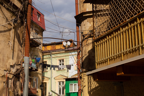 敖德萨，乌克兰- 04 24 21:旧建筑立面的一部分，有窗户和阳台。老城区典型的房子里有亚麻和晾衣绳。阳光明媚的春天的照片图片下载