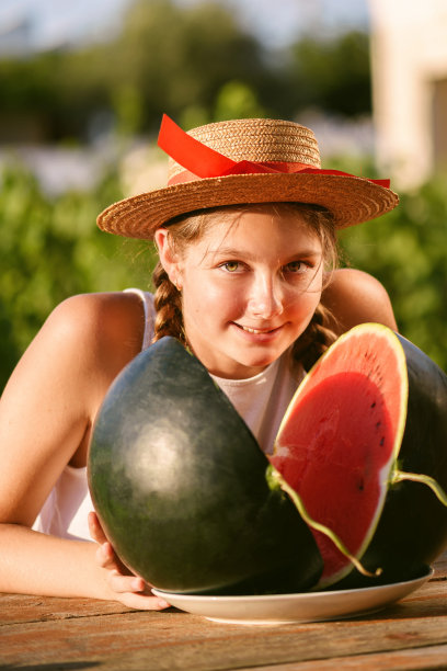快乐的女孩在户外享受和吃西瓜的肖像，慢生活。夏天的生活方式图片下载