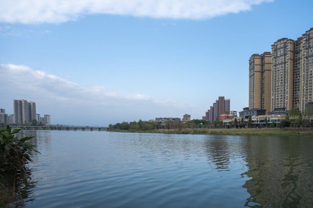 阳光明媚的河流与现代建筑图片下载